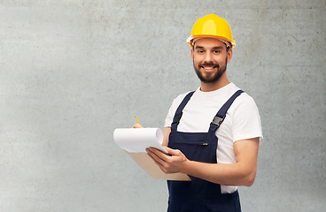 Image showing male worker or builder in helmet with clipboard