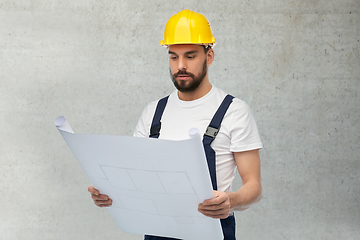 Image showing male worker or builder in helmet with blueprint