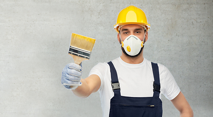 Image showing worker or builder in respirator with brush