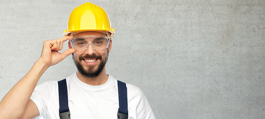 Image showing happy male worker or builder in helmet and overall