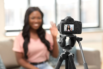 Image showing female blogger with camera video blogging at home