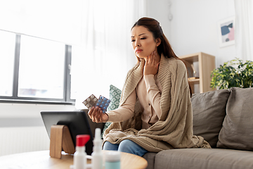 Image showing sick woman with medicine has video consultation