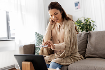 Image showing sick woman having video call on tablet computer