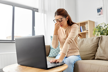 Image showing tired woman with laptop working at home office