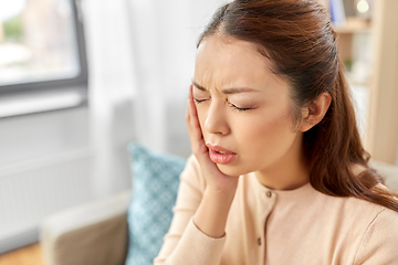 Image showing asian woman suffering from toothache at home