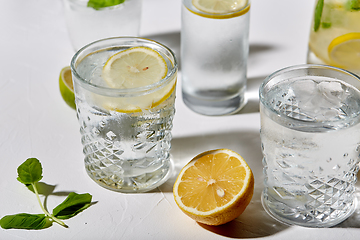 Image showing glasses with lemon water and peppermint on table