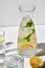 Image showing glasses with lemon water and peppermint on table