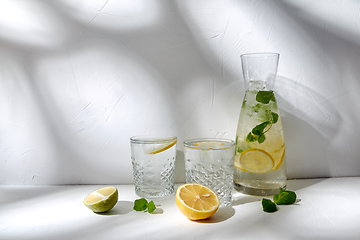 Image showing glasses with lemon water and peppermint on table