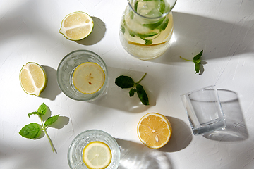 Image showing glasses with lemon water and peppermint on table