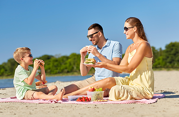 Image showing happy family having picnic on summer beach