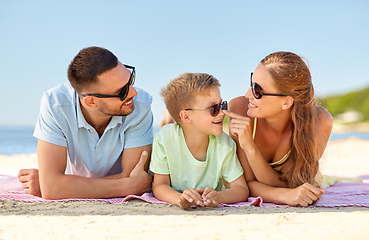 Image showing happy family lying on summer beach