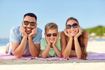 Image showing happy family lying on summer beach