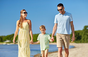 Image showing happy family walking along summer beach