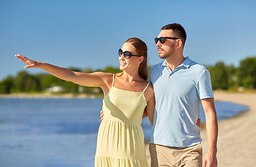 Image showing happy couple hugging on summer beach