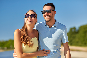 Image showing happy couple hugging on summer beach