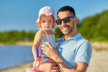 Image showing happy father with little daughter on beach