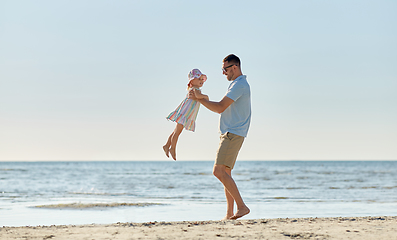 Image showing happy father playing with little daughter on beach