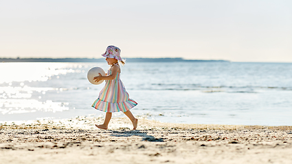 Image showing happy baby girl with ball running on summer beach