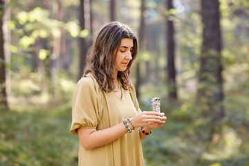 Image showing woman or witch performing magic ritual in forest