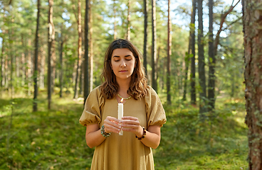 Image showing woman or witch performing magic ritual in forest