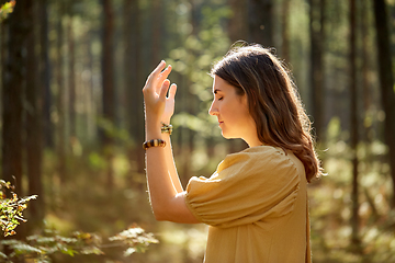 Image showing woman or witch performing magic ritual in forest