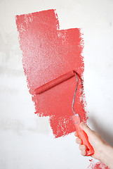 Image showing painting a wall with a roll
