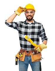 Image showing happy male worker or builder in helmet with level