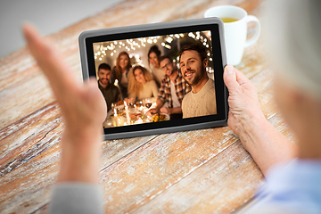 Image showing old woman has video call with family on christmas