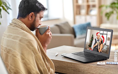 Image showing sick man having video call with friends at home