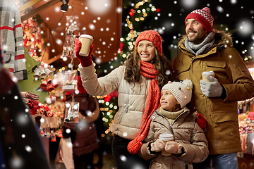 Image showing family with takeaway drinks at christmas market