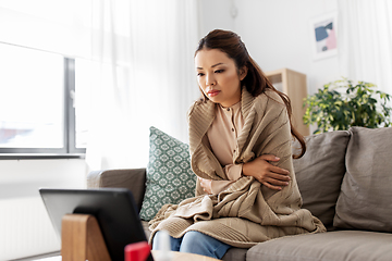 Image showing sick woman having video call on tablet pc at home