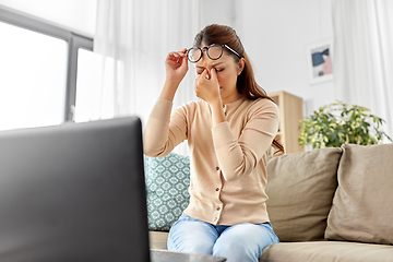 Image showing tired woman with laptop working at home office