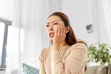 Image showing asian woman suffering from toothache at home