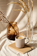 Image showing cup of coffee, diary and dried flowers in vases