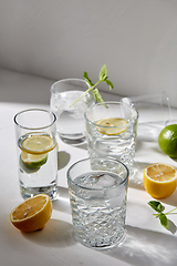 Image showing glasses with lemon water and peppermint on table