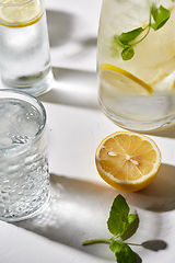 Image showing glasses with lemon water and peppermint on table