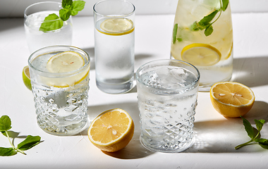 Image showing glasses with lemon water and peppermint on table