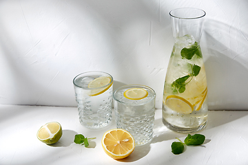 Image showing glasses with lemon water and peppermint on table