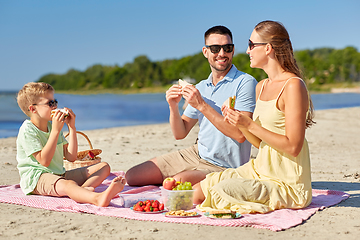 Image showing happy family having picnic on summer beach