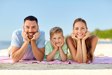 Image showing happy family lying on summer beach