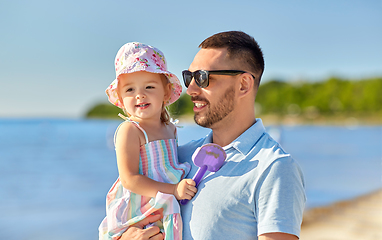 Image showing happy father with little daughter on beach