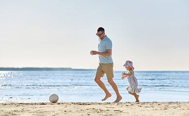 Image showing happy father and daughter playing ball on beach