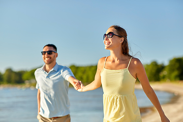 Image showing happy couple hugging on summer beach