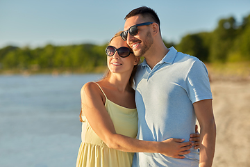 Image showing happy couple hugging on summer beach