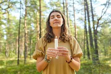 Image showing woman or witch performing magic ritual in forest