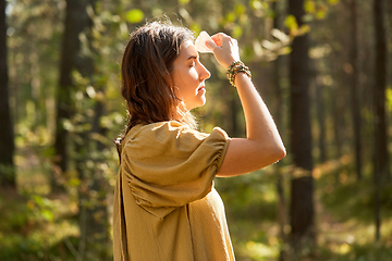 Image showing woman or witch performing magic ritual in forest