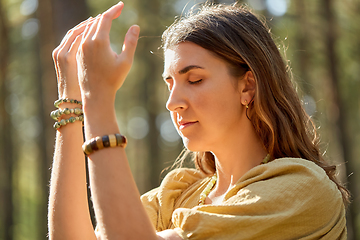 Image showing woman or witch performing magic ritual in forest