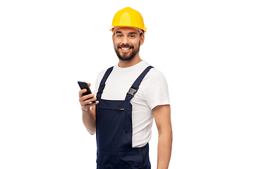 Image showing happy male worker or builder with smartphone