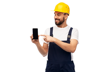 Image showing happy male worker or builder showing smartphone