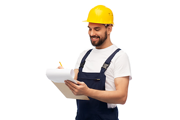 Image showing male worker or builder in helmet with clipboard